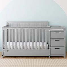 a baby crib in a room with blue walls