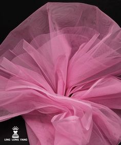 a pink tulle on top of a black surface