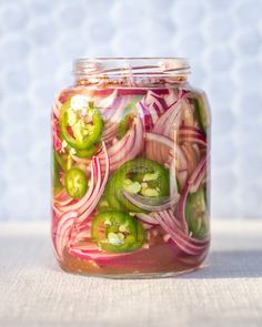 a mason jar filled with pickles and onions