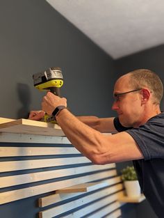 DIY Slat Wall with Shelves - Life with Less Mess Slat Wall Office Organization, Wood Slat Wall With Floating Shelves, Horizontal Slats Wall, Geometric Wall Slats, Horizontal Wood Slats On Wall, 1x2 Accent Wall Horizontal, Slate Wall With Shelves, 2x2 Slat Wall, Wooden Slat Wall With Shelves