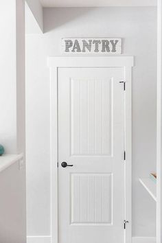 a white door with the word pantry above it