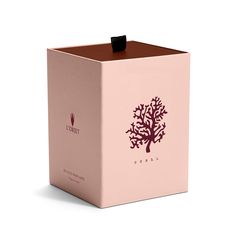 a pink box with a brown tree on it's side and the lid is open