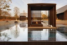 an outdoor pool with a wooden gazebo next to it