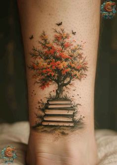 a woman's foot with a tree and books on it