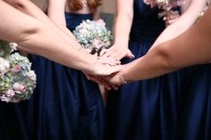 the bridesmaids are holding hands with each other