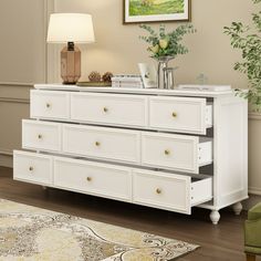 a white dresser sitting on top of a hard wood floor