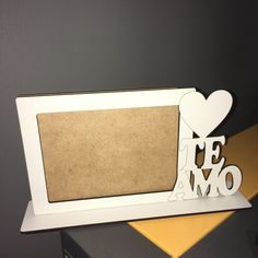 a white photo frame with the word love on it