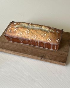 a loaf of bread sitting on top of a wooden cutting board