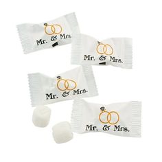 three candy bags with wedding rings and mr and mrs written on the front one is white