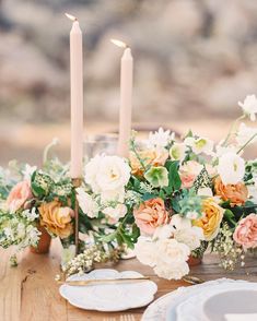 a table with candles and flowers on it