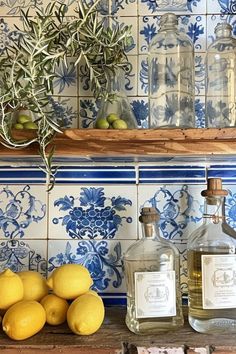 some lemons are sitting on a shelf next to bottles