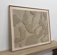 a painting is hanging on the wall next to a shelf