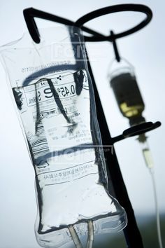 an iv bag is attached to the back of a medical device in front of a sky background