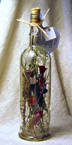 a glass bottle filled with flowers on top of a table