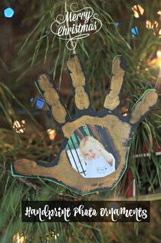 a handprint ornament hanging from a christmas tree