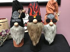 three gnomes wearing hats and sunglasses on top of a table