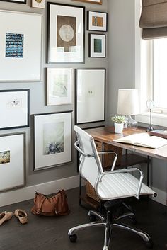 a home office with framed pictures on the wall