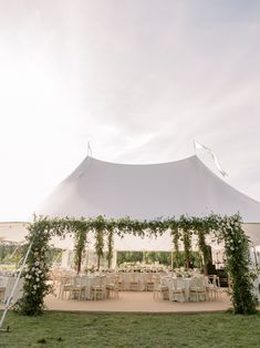 an outdoor tent set up with tables and chairs