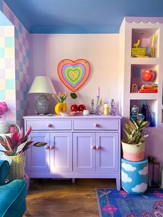 a living room filled with lots of furniture and colorful decor on top of it's walls