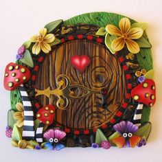 a close up of a wooden door with flowers and plants on it's side