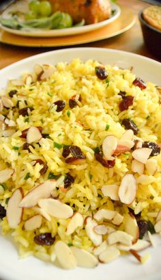 a white plate topped with rice and almonds