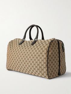 Few styles can live up to the status of an investment piece quite the way Gucci's duffle bag will. It's been crafted in Italy from hardwearing coated-canvas mapped with the house's distinctive 'GG' monogram and is finished with supple leather accents, including sturdy top handles. Internal and external organisation keeps travel essentials neatly grouped. Gucci Duffle Bag, Duffle Bag For Men, Cow Tops, Gucci Collection, Canvas Duffle Bag, Gg Monogram, Summer Sunglasses, Gucci Leather, Leather Accents