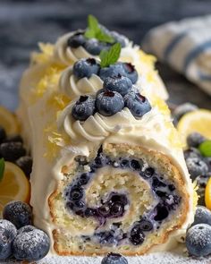 blueberry lemon roll with frosting and fresh berries