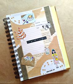 an open notebook with stickers on it