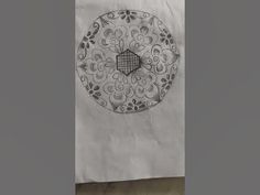 a paper bag with an intricate design on the front and side, in black and white