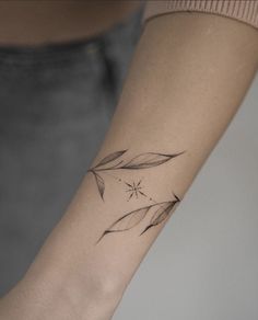 a woman's arm with a small tattoo design on the left side of her wrist