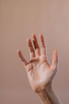 a person's hand reaching up into the air