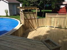 a wooden deck next to a swimming pool