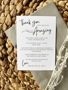 a wedding thank card on top of a woven place mat next to an envelope with the words, thank you for making one day amazing