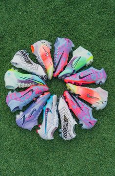 a circle of shoes sitting on top of a lush green field