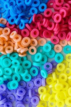 many different colors of plastic beads on a table