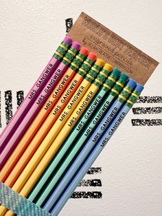 a group of colored pencils sitting next to each other