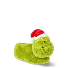 a green stuffed animal with a santa hat on it's head is laying down