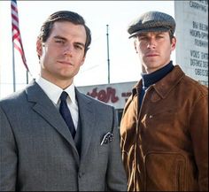 two men in suits and ties standing next to each other