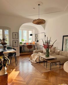 a living room filled with furniture and lots of windows