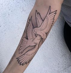 a person with a bird tattoo on their arm