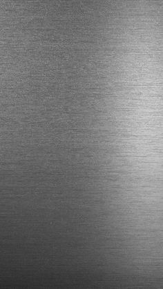 a black and white photo of a shiny metal surface that looks like it could be used as a background