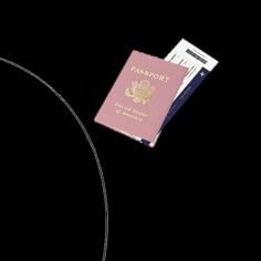 a pink passport sitting on top of a white table