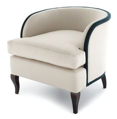 a beige chair with black trim around the arms