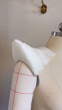 a mannequin's torso is covered in white fabric