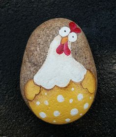 a painted rock with a chicken on it