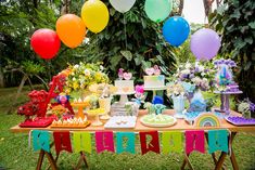 an outdoor party with balloons and decorations