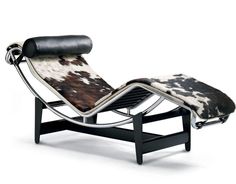 an animal print chaise lounge chair with black frame and leather cushion on white background