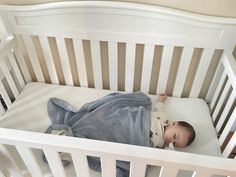 a baby is sleeping in his crib