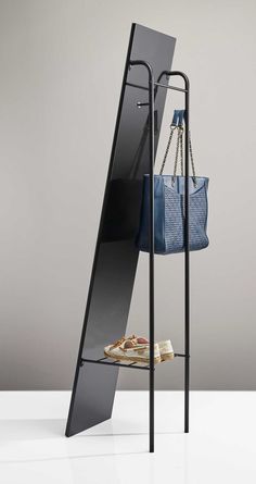 a blue purse sitting on top of a metal shelf next to a pair of shoes