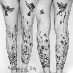 the legs are covered in tattoos with birds and flowers on them, as well as plants